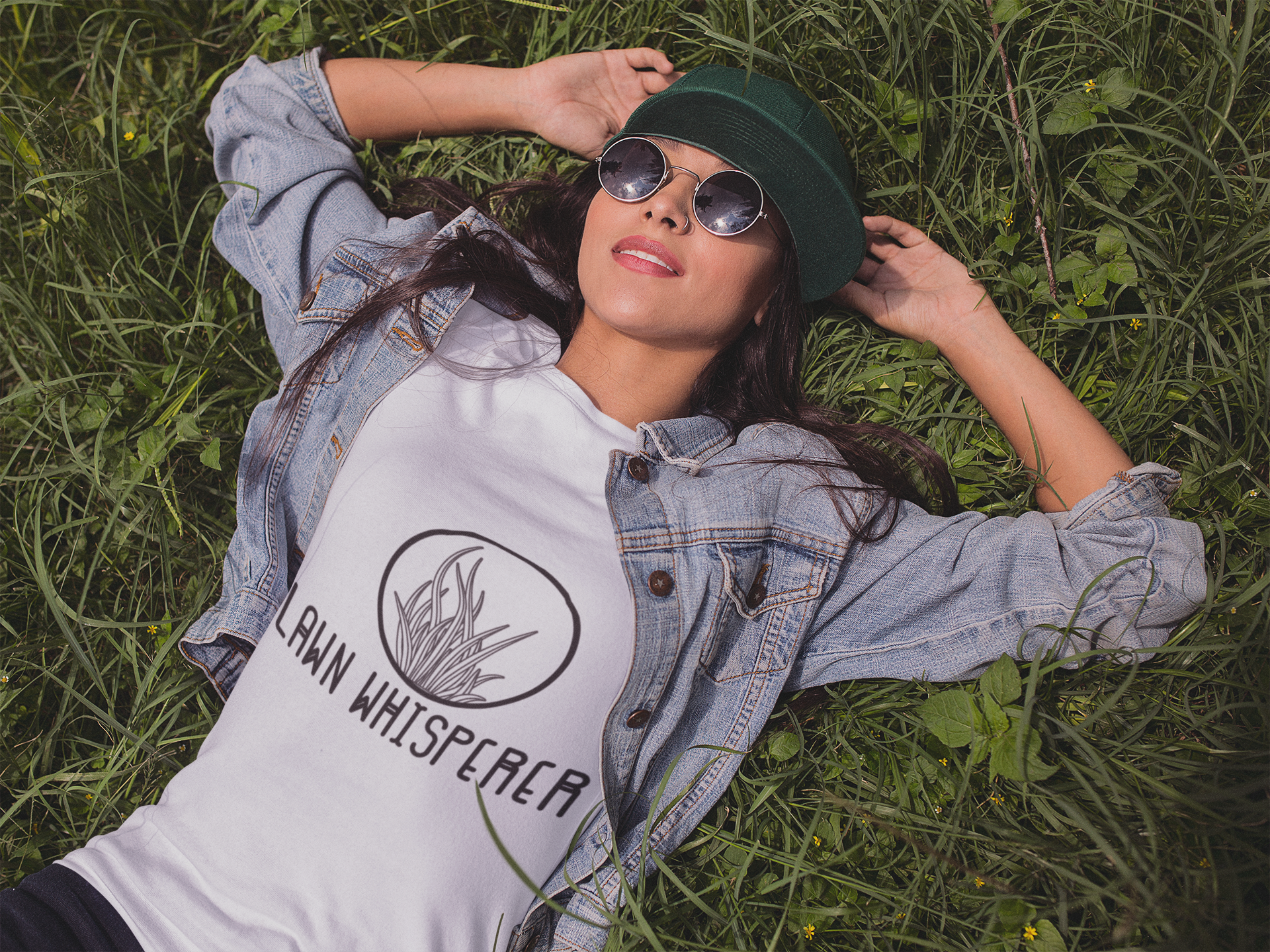 Female laying in grass wearing a white boho 